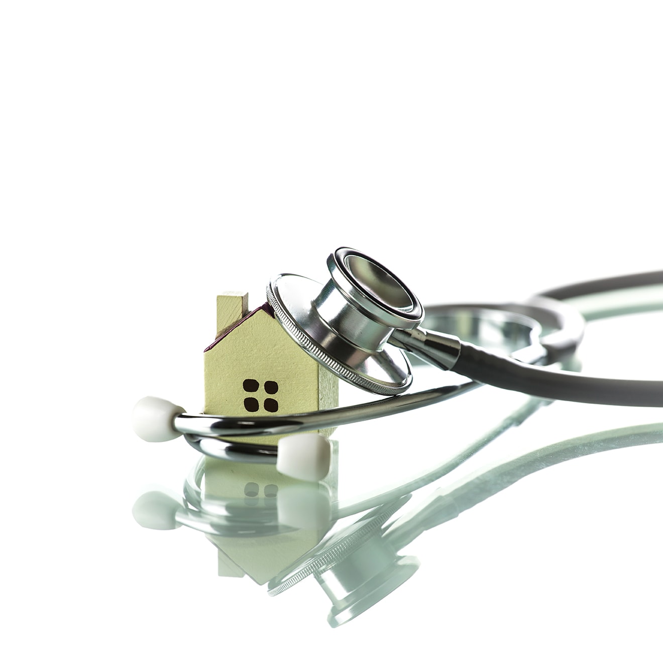 Stethoscope and house model representing home health care